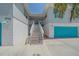 Two story home features an elevated entrance staircase, turquoise garage door, and coastal charm at 3711 118Th W St, Bradenton, FL 34210