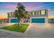 Charming two-story home with updated facade, blue garage doors and tropical landscaping at 3711 118Th W St, Bradenton, FL 34210