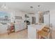Well-lit kitchen features white cabinets, stainless appliances, and a quartz countertop island at 3711 118Th W St, Bradenton, FL 34210
