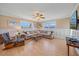 Bright living room with large windows, hardwood flooring, comfortable seating, and neutral décor creates a relaxing space at 3711 118Th W St, Bradenton, FL 34210