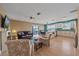 Open concept living room and kitchen with modern furnishings and ample natural light at 3711 118Th W St, Bradenton, FL 34210