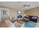 Comfortable living room featuring a fireplace, plush seating, and a ceiling fan at 3711 118Th W St, Bradenton, FL 34210