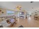 Comfortable living room with hardwood floors, neutral colors, a sectional sofa and seamless transition into the kitchen and dining area at 3711 118Th W St, Bradenton, FL 34210
