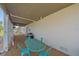 Outdoor seating area with a turquoise table and chairs on a gravel bed with a white exterior wall at 3711 118Th W St, Bradenton, FL 34210