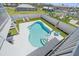An aerial view of a private pool with a white fence and lounge chairs perfect for outdoor relaxation and enjoyment at 3711 118Th W St, Bradenton, FL 34210