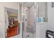 Modern shower with gray and white tiles, glass door, and a view into the closet at 3711 118Th W St, Bradenton, FL 34210