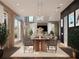 Well-lit dining room flowing into the living room with modern light fixture and gray dining chairs at 3847 30Th S Ave, St Petersburg, FL 33711