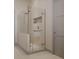 Modern shower with frameless glass enclosure, built-in niche, and hand towel bar at 3847 30Th S Ave, St Petersburg, FL 33711