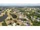 Wide aerial view of a property nestled within a lush golf course community with serene water features at 3859 Little Country Rd, Parrish, FL 34219