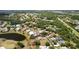 Expansive aerial view of a community with lush green landscaping, ponds, and a well-maintained golf course at 3859 Little Country Rd, Parrish, FL 34219