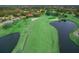 Scenic aerial view of the lush golf course with mature trees and water features at 3859 Little Country Rd, Parrish, FL 34219