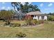 Beautifully landscaped backyard with an inground pool and screened enclosure offering privacy and leisure at 3859 Little Country Rd, Parrish, FL 34219