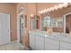 Bathroom with double sink vanity, tile floor, and decorative lighting at 3859 Little Country Rd, Parrish, FL 34219