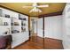 The guest bedroom offers built-in shelving and access to the ensuite bathroom at 3859 Little Country Rd, Parrish, FL 34219