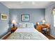 Serene bedroom with blue walls, wooden desk and side table lamps at 3859 Little Country Rd, Parrish, FL 34219