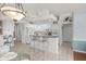 Open kitchen with breakfast bar and views into the dining and living spaces at 3859 Little Country Rd, Parrish, FL 34219