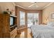 Comfortable main bedroom with wood floors, natural light, ceiling fan, and neutral tones at 3859 Little Country Rd, Parrish, FL 34219