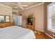 Relaxing main bedroom with wood floors, ceiling fan, and abundant natural light at 3859 Little Country Rd, Parrish, FL 34219
