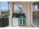 Outdoor kitchen area with sink, mini-refrigerator and cabinet space, next to the barbecue area at 3859 Little Country Rd, Parrish, FL 34219