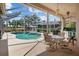 Inviting screened-in pool area with a covered lanai and well maintained patio at 3859 Little Country Rd, Parrish, FL 34219