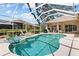 Enjoy this screened pool and hot tub with sunny Florida weather and lush landscaping at 3859 Little Country Rd, Parrish, FL 34219