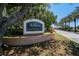 The entrance to River Wilderness Golf & Country Club is well-maintained with manicured flowers at 3859 Little Country Rd, Parrish, FL 34219