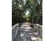 Charming wooden boardwalk shaded by trees, leading to a peaceful outdoor adventure and a connection with nature at 3901 30Th S Ave, St Petersburg, FL 33711