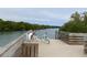 Dock view, with two bicycles, overlooking tranquil waters edged with verdant greenery at 3901 30Th S Ave, St Petersburg, FL 33711