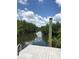 Scenic view of the tranquil waterfront featuring lush greenery and a clear blue sky with white clouds at 3901 30Th S Ave, St Petersburg, FL 33711