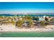 Aerial view of a vibrant beach town featuring waterfront dining and a clear blue ocean at 4501 20Th S Ave, St Petersburg, FL 33711