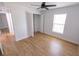 Bright bedroom features wood-look flooring, ceiling fan, window, and closet space at 4501 20Th S Ave, St Petersburg, FL 33711