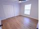 Bedroom with closet, new window, modern ceiling fan, and attractive wood-look floors at 4501 20Th S Ave, St Petersburg, FL 33711