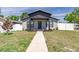 Charming single-Gathering home featuring updated facade, landscaped front yard, and walkway to covered entrance at 4501 20Th S Ave, St Petersburg, FL 33711