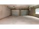 Spacious two car garage with bare cement walls, painted floor, and two garage doors at 4501 20Th S Ave, St Petersburg, FL 33711