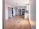 Open-concept kitchen with stainless steel appliances, white cabinets, and hardwood floors, seamlessly integrated with living space at 4501 20Th S Ave, St Petersburg, FL 33711