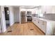 Modern kitchen with white cabinets, stainless steel appliances, and a sleek design, open to the living area at 4501 20Th S Ave, St Petersburg, FL 33711