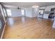 Bright, open-concept living room featuring wood flooring, modern lighting, and stainless steel kitchen appliances at 4501 20Th S Ave, St Petersburg, FL 33711