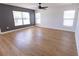 Living room with modern ceiling fan, many windows, and attractive wood-look floors at 4501 20Th S Ave, St Petersburg, FL 33711