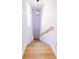 Bright stairway with wooden steps and handrail leads to a white door with a decorative light fixture at 4501 20Th S Ave, St Petersburg, FL 33711
