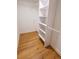 Walk-in closet with custom shelving, rod, and attractive wood-look floors at 4501 20Th S Ave, St Petersburg, FL 33711