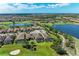 An aerial view highlighting an elegant home with a screened-in pool on the golf course at 4607 Benito Ct, Bradenton, FL 34211