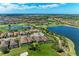 An aerial view showcasing a lakefront community, golf course and luxurious homes on a sunny day at 4607 Benito Ct, Bradenton, FL 34211