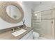 Bathroom features a modern vanity, decorative mirror, and glass-enclosed shower with tiled surround at 4607 Benito Ct, Bradenton, FL 34211