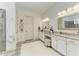Elegant bathroom with dual vanities, patterned tile flooring, shiplap walls, and luxurious finishes at 4607 Benito Ct, Bradenton, FL 34211