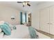 Bedroom with ensuite bathroom, closet, and a large bed with decorative pillows and a throw at 4607 Benito Ct, Bradenton, FL 34211