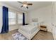 Inviting bedroom with a relaxing atmosphere, including a ceiling fan and stylish blue accents at 4607 Benito Ct, Bradenton, FL 34211