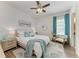 Comfortable bedroom featuring calming turquoise accents, ceiling fan, and stylish decor at 4607 Benito Ct, Bradenton, FL 34211