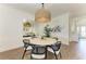 Cozy dining area with a round table, stylish chairs, and a statement lighting fixture at 4607 Benito Ct, Bradenton, FL 34211