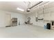 Spacious garage with epoxy flooring, storage shelves, and stainless steel refrigerator at 4607 Benito Ct, Bradenton, FL 34211