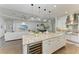 Gourmet kitchen boasts an island with seating, wine cooler, pendant lights, and open concept living area at 4607 Benito Ct, Bradenton, FL 34211